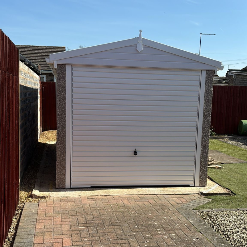 Apex concrete garage with white fascias